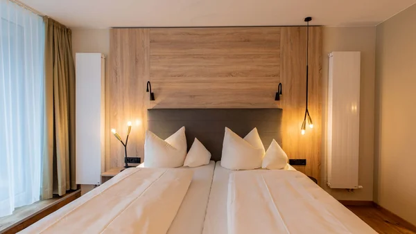 Modernes Schlafzimmer mit zwei Einzelbetten und warmen Lichtern